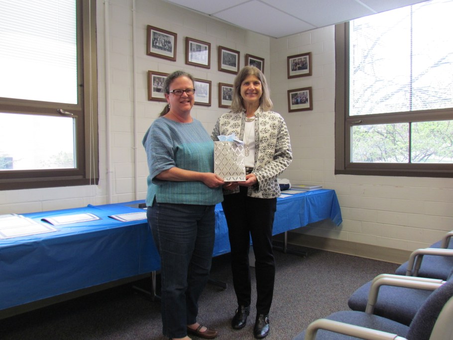 Dr. Carolee Bull (R) presenting a gift to Dr. Gretchen Kuldau (L) who is concluding her service as Director of Graduate Studies.