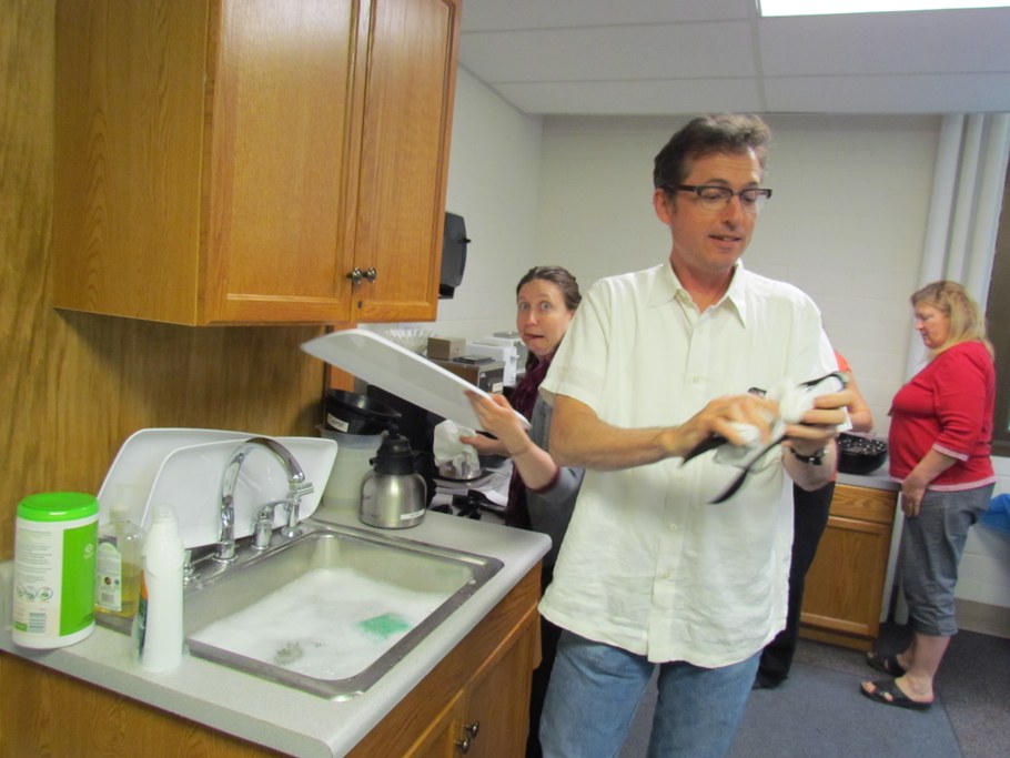 Dr. David Geiser (R) washing dishes with Sara May (L)