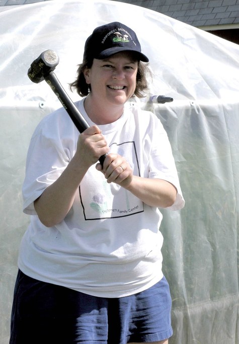 Dr. Kuldau takes the mallet to drive the stakes for the small plot incubation chambers.